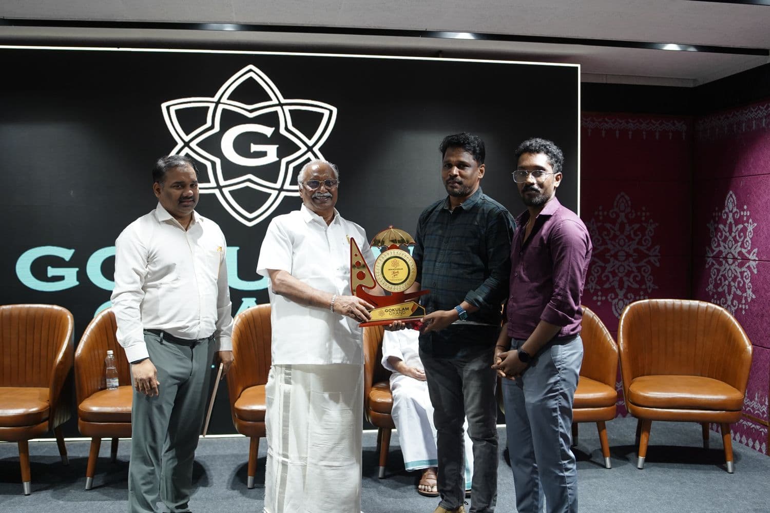 Receiving a memento at the Gokulam event